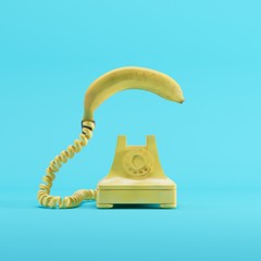 Wall Mural - Banana phone with yellow vintage telephone on blue pastel color background. minimal idea concept.