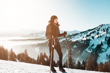 Wall Mural - female hiker against winter snowy mountains