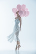 © LIGHTFIELD STUDIOS - tender ballet dancer in white dress with pink balloons, isolated on white