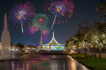 Crowd of People Watching Fireworks at Suanluang RAMA IX, public park in Bangkok, Thailand. Fireworks Light up the Sky, New Year Celebration.