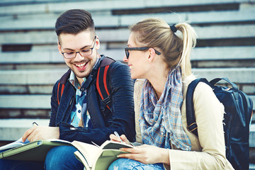 Student Couple Holding Diplomas