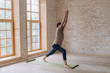 © yuliyalyashok - Relaxed young man doing yoga and meditating in studio