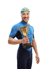 Canvas Print - Swimmer holding a golden trophy and smiling