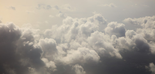 storm clouds, colorful, heavy on blue sky background. aerial photo from plane's window, banner
