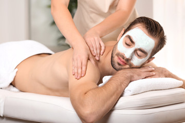 Poster - Young man having massage in spa salon