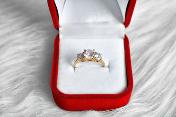 Wall Mural - Beautiful engagement ring in box on white fur