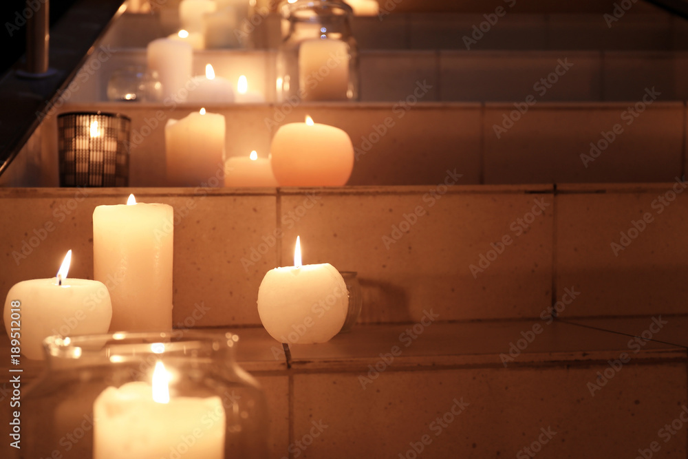 Burning candles on stairs