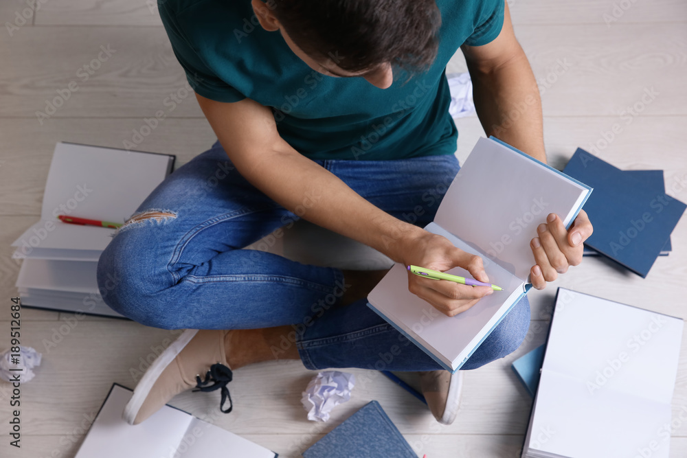 Male student preparing for exam indoors