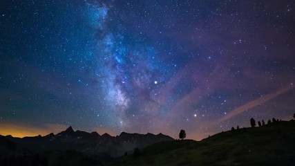 Wall Mural - astro time lapse milky way and stars rotating over the majestic italian french alps in summertime. s