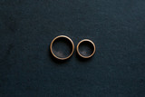 Fototapeta Konie - Wedding rings look from above on a black background