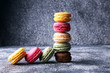 Sweet and colourful french macaroons or macaron on grey background, Dessert