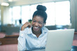 © kosim - Cheerful African girl at notebook in office