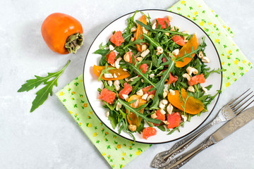 Fresh salad with salmon and persimmon