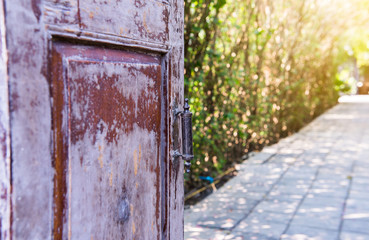 Old wooden door open with old metal door handle