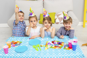 Happy group of children celebrating friends birthday. Kids party