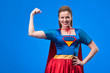 © LIGHTFIELD STUDIOS - portrait of smiling woman in superhero costume showing muscles isolated on blue