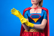 © LIGHTFIELD STUDIOS - cropped shot of woman in superhero costume wearing rubber gloves isolated on blue
