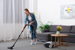 © LIGHTFIELD STUDIOS - attractive woman with vacuum cleaner cleaning room at home