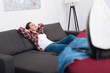 © LIGHTFIELD STUDIOS - selective focus of woman resting on sofa at home with iron in front