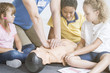 Paramedic showing children chest compressions