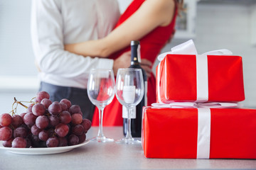 Wall Mural - Close up shot of gift boxes, bottle of wine and grape on table