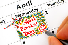 Woman Fingers With Pen Writing Reminder April Fools Day In Calendar.