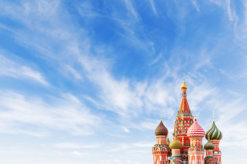 domes of saint basil cathedral on blue sky background. famous landmark of moscow, russia. bright sun