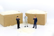 © polymanu - Miniature people : Businessmen set the price of grain sales. Image use for business food concept.