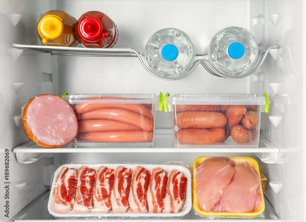Refrigerator with fresh meat products, closeup