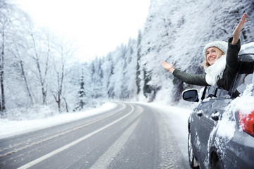 Sticker - Happy tourist enjoying the beauty of snowy landscape while travelling by car