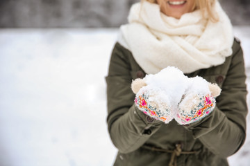 Sticker - Woman holding snow in hands on winter day