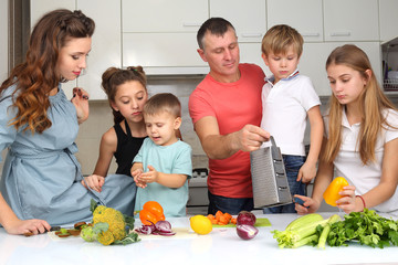 Poster - family with children cut vegetables for cooking