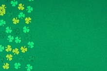 St Patricks Day Side Border Of Paper Shamrocks Over A Green Textured Background