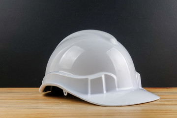 HEALTH AND SAFETY CONCEPT. Personal protective equipment on wooden table over black background.