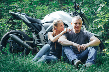 Wall Mural - The motorcyclist and the girl in the forest