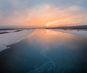 Poster - shooting with quadrocopter winter landscape evening sunset over the frozen river aerial photography