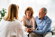 © Halfpoint - Female doctor talking to a senior couple.