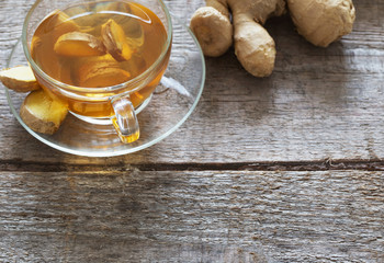 Wall Mural - Ginger tea and ingredients on a  grunge wooden background