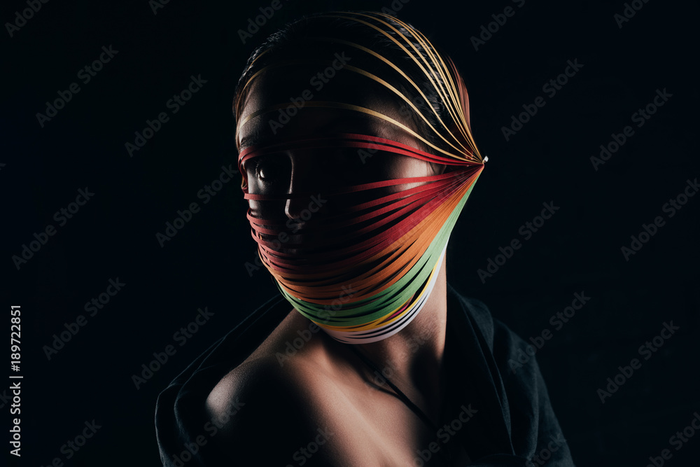 woman with colored quilling paper on head looking away isolated on black - obrazy, fototapety, plakaty 