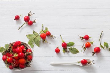 Wall Mural - berries of a dogrose on a wooden background