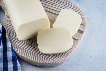 White mozzarella on blue concrete stone background table. Healthy Food Concept. Daily product. Copy space