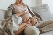 © LIGHTFIELD STUDIOS - cropped image of daughter sleeping on pregnant mother legs