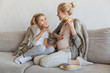 © LIGHTFIELD STUDIOS - happy pregnant mother and daughter eating donuts