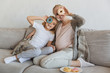 © LIGHTFIELD STUDIOS - happy pregnant mother and daughter covering eyes with donuts