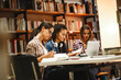 © BalanceFormCreative - Group of female students study in the school library.Learning and preparing for university exam.Education concept.