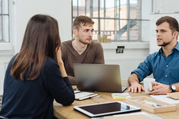 Wall Mural - Three young businesspeople in a meeting