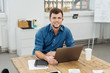 © contrastwerkstatt - Young cheerful man working with laptop