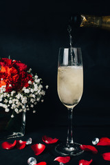 Concept picture for Valentine's day. 2 glasses of Champaign with rose petal, strawbery and flower