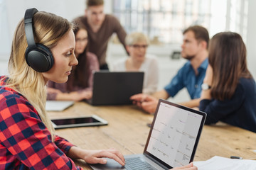 Young businesswoman working wearing headphones