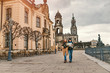 © EdNurg - Two charming cheerful women are walking with a map along Dresden Street, Germany. The concept of love and friendship in travel